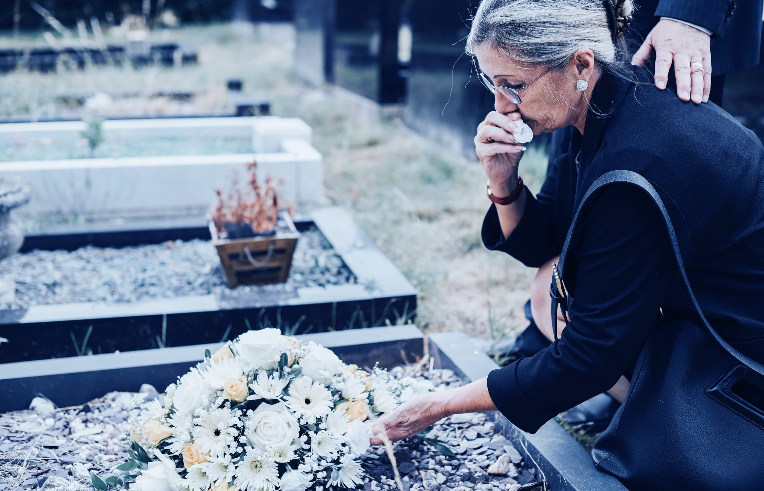 mother crying at grave